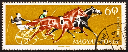 HUNGARY - CIRCA 1961: a stamp printed in the Hungary shows Two Trotters, Horse Racing, circa 1961のeditorial素材