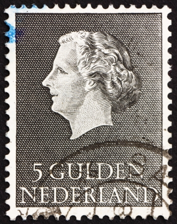 NETHERLANDS - CIRCA 1955: a stamp printed in the Netherlands shows Queen Juliana, circa 1955のeditorial素材
