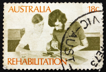 AUSTRALIA - CIRCA 1972: a stamp printed in the Australia shows Amputee Assembling Electrical Circuit, Rehabilitation of the Handicapped, circa 1972のeditorial素材