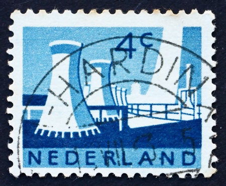 NETHERLANDS - CIRCA 1963: a stamp printed in the Netherlands shows Cooling Towers, Limburg State Coal Mines, circa 1963のeditorial素材