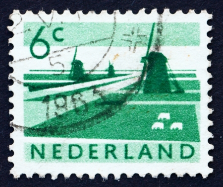 NETHERLANDS - CIRCA 1962: a stamp printed in the Netherlands shows Polder with Canals and Windmills, circa 1962のeditorial素材