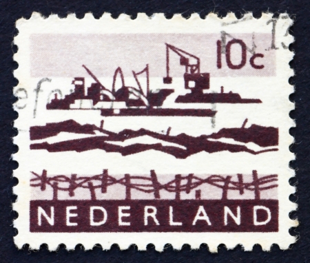 NETHERLANDS - CIRCA 1963: a stamp printed in the Netherlands shows Dredging in Delta, circa 1963のeditorial素材