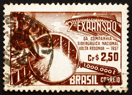 BRAZIL - CIRCA 1957: a stamp printed in the Brazil shows Symbolical of Steel Production, 2nd Expansion of the National Steel Company at Volta Redonda, circa 1957のeditorial素材