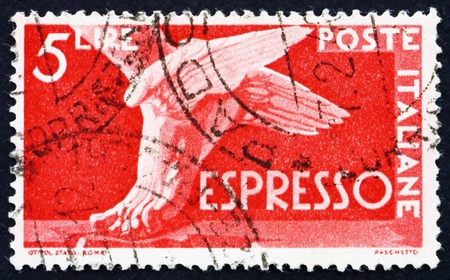 ITALY - CIRCA 1945: a stamp printed in the Italy shows Winged Foot, circa 1945のeditorial素材