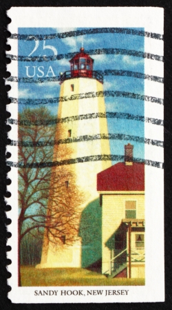 UNITED STATES OF AMERICA - CIRCA 1990: a stamp printed in the USA shows Sandy Hook, New Jersey, Lighthouse, circa 1990のeditorial素材