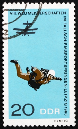 GDR - CIRCA 1966: a stamp printed in GDR shows Parachutist in Free Fall, 8th International Parachute Championships, Leipzig, circa 1966のeditorial素材
