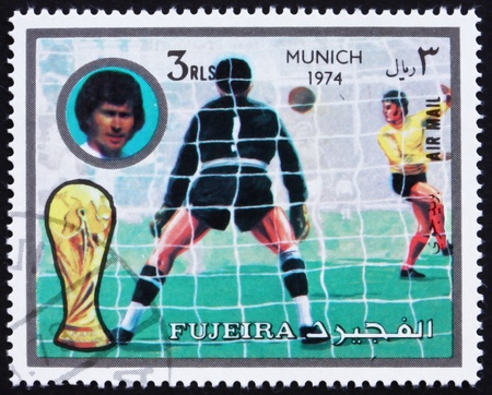 FUJEIRA - CIRCA 1972: a stamp printed in the Fujeira shows Football Scene, Football World Championship 1974, Germany, circa 1972のeditorial素材