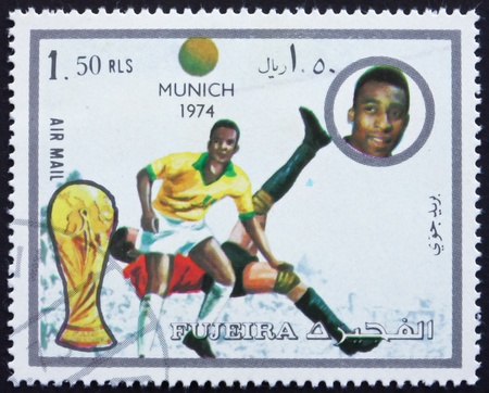 FUJEIRA - CIRCA 1972: a stamp printed in the Fujeira shows Football Scene, Football World Championship 1974, Germany, circa 1972のeditorial素材