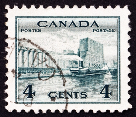 CANADA - CIRCA 1942 a stamp printed in the Canada shows Grain Elevators in Harbor, circa 1942のeditorial素材