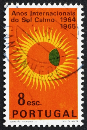 PORTUGAL - CIRCA 1964: a stamp printed in the Portugal shows Partial Eclipse of Sun, International Quiet Sun Year, circa 1964のeditorial素材