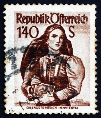 AUSTRIA - CIRCA 1948: a stamp printed in the Austria shows Woman from Upper Austria, Inn District, Regional Costume, circa 1948のeditorial素材