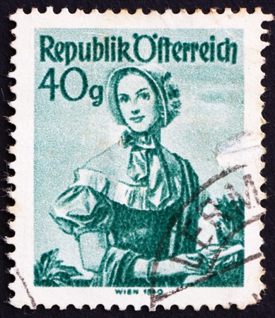 AUSTRIA - CIRCA 1949: a stamp printed in the Austria shows Woman from Vienna, 1840, Regional Costume, circa 1949のeditorial素材