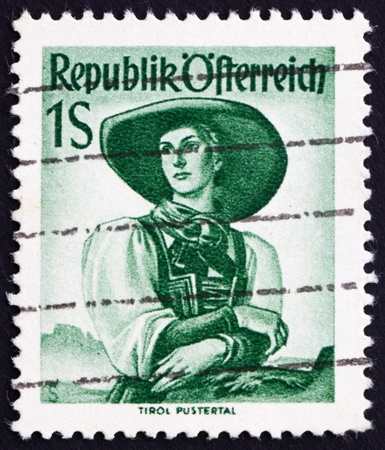 AUSTRIA - CIRCA 1948: a stamp printed in the Austria shows Woman from Tyrol, Puster Valley, Regional Costume, circa 1948のeditorial素材