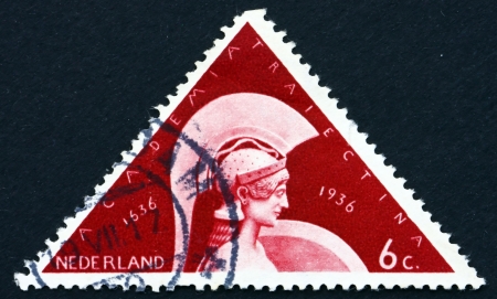 NETHERLANDS - CIRCA 1936: a stamp printed in the Netherlands shows Minerva, 300th Anniversary of Founding of the University at Utrecht, circa 1936のeditorial素材
