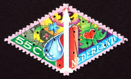 NETHERLANDS - CIRCA 1989: a stamp printed in the Netherlands shows Star, Candle, Christmas Tree, Christmas, circa 1989のeditorial素材