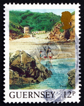 GUERNSEY - CIRCA 1988: a stamp printed in the Guernsey shows Petit Bot Beach, Landscape, circa 1988のeditorial素材