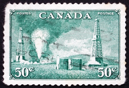 CANADA - CIRCA 1950: a stamp printed in the Canada shows Oil Wells, Alberta, Development of Oil Wells in Canada, circa 1950のeditorial素材