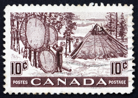 CANADA - CIRCA 1950: a stamp printed in the Canada shows Indians Drying Skins on Stretchers, Fur Resources, circa 1950のeditorial素材