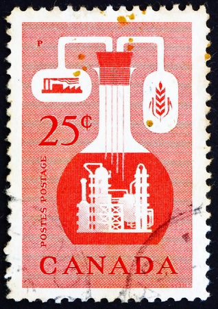 CANADA - CIRCA 1956: a stamp printed in the Canada shows Chemical Industry, circa 1956のeditorial素材