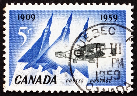 CANADA - CIRCA 1959: a stamp printed in the Canada shows Silver Dart and Delta Wing Planes, 50th Anniversary of the 1st Airplane Flight in Canada near Baddeck, circa 1959のeditorial素材