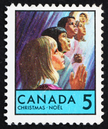 CANADA - CIRCA 1969: a stamp printed in the Canada shows Children of Various Races, Christmas, circa 1969のeditorial素材