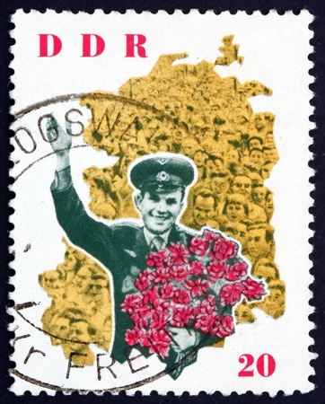 GDR - CIRCA 1963: a stamp printed in GDR shows Yuri Gagarin and map of DDR, Visit of Astronaut Yuri Gagarin to the German Democratic Republic, circa 1963のeditorial素材