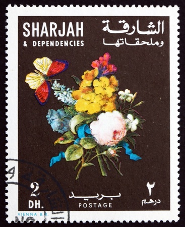 SHARJAH - CIRCA 1967: a stamp printed in the Sharjah UAE shows Bunch of Flowers and Butterfly, circa 1967のeditorial素材