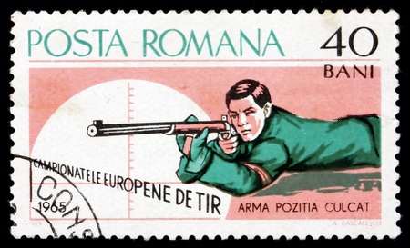 ROMANIA - CIRCA 1965: a stamp printed in the Romania shows Rifle Shooting, Prone, European Shooting Championships, Bucharest, circa 1965のeditorial素材