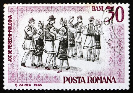 ROMANIA - CIRCA 1966: a stamp printed in the Romania shows Folk Dancers of Moldavia, Traditional Folk Dance, circa 1966のeditorial素材