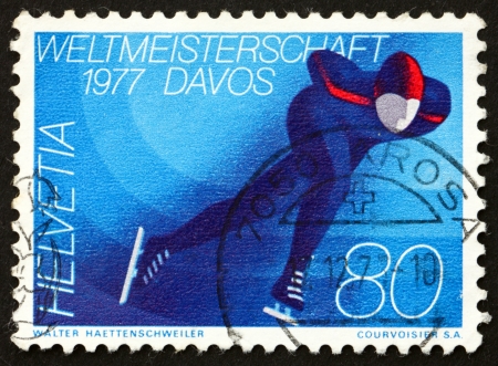 SWITZERLAND - CIRCA 1977: a stamp printed in the Switzerland shows Skater, World Mens Skating Championships, Davos, circa 1977のeditorial素材