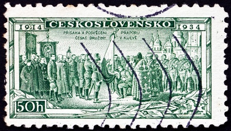 CZECHOSLOVAKIA - CIRCA 1934: a stamp printed in the Czechoslovakia shows Consecration of Legion Colors at Kiev, 20th Anniversary of Legion which Fought in WWI, circa 1934のeditorial素材