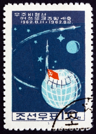 NORTH KOREA - CIRCA 1962: a stamp printed in North Korea shows Launch of Soviet Manned Rockets Vostok 3 and Vostok 4, circa 1962のeditorial素材