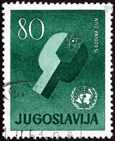YUGOSLAVIA - CIRCA 1960: a stamp printed in the Yugoslavia shows Atom and UN Emblem, 15th Anniversary of UN, circa 1960のeditorial素材