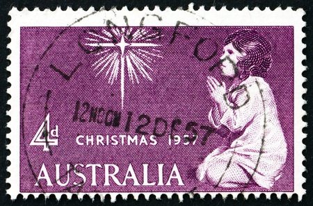 AUSTRALIA - CIRCA 1957: a stamp printed in the Australia shows Praying Child and Star of Bethlehem, Christmas, circa 1957のeditorial素材