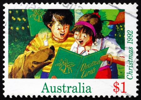 AUSTRALIA - CIRCA 1992: a stamp printed in the Australia shows Boy and Girl Singing Christmas Carol, Christmas, circa 1992のeditorial素材