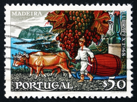 PORTUGAL - CIRCA 1968: a stamp printed in the Portugal shows Madeira Grapes and Wine, circa 1968のeditorial素材