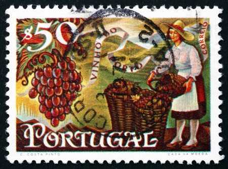 PORTUGAL - CIRCA 1970: a stamp printed in the Portugal shows Grapes and Woman Filling Baskets, Port Wine Export, circa 1970のeditorial素材