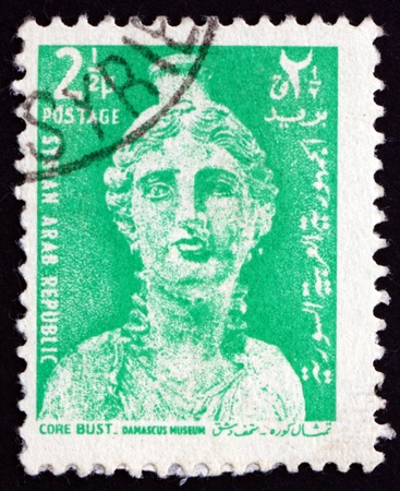 SYRIA - CIRCA 1966: a stamp printed in the Syria shows Bust of Core, Terra Cotta Vase, circa 1966のeditorial素材