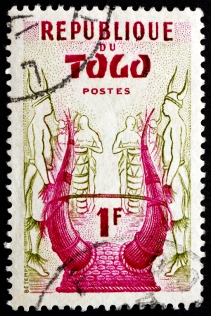 TOGO - CIRCA 1957: a stamp printed in Togo shows Konkomba Helmet, circa 1957のeditorial素材