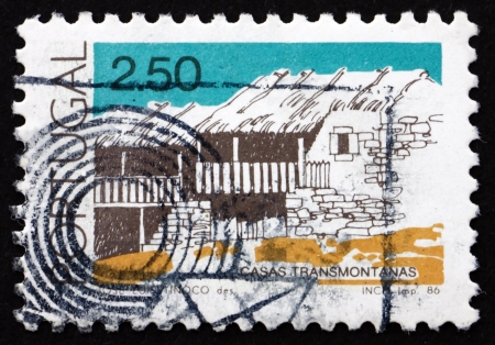 PORTUGAL - CIRCA 1986: a stamp printed in the Portugal shows Transmontanas, Traditional Architecture, circa 1986のeditorial素材