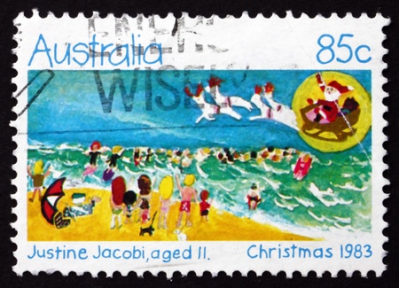 AUSTRALIA - CIRCA 1983: a stamp printed in the Australia shows Holiday Beach Scene, Design by Justine Jacobi, Aged 11, Christmas, circa 1983のeditorial素材
