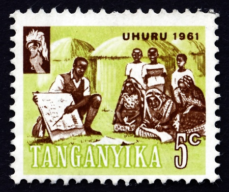 TANGANYIKA - CIRCA 1961: a stamp printed in Tanganyika shows Teacher Instructing Villagers, circa 1961のeditorial素材