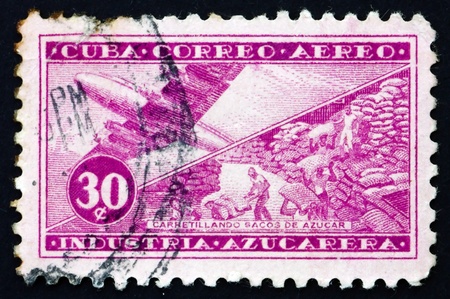CUBA - CIRCA 1954: a stamp printed in the Cuba shows Plane and Sacks of Sugar, Sugar Production, circa 1954のeditorial素材