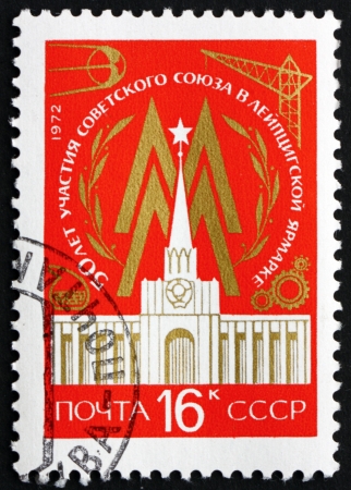 RUSSIA - CIRCA 1972: a stamp printed in the Russia shows Leipzig Fair Emblem and Soviet Pavilion, 50th Anniversary of the Participation of the USSR, circa 1972のeditorial素材