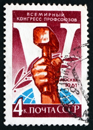 RUSSIA - CIRCA 1961: a stamp printed in the Russia shows Hand Holding Hammer, Fifth Congress of Trade Unions, Moscow, circa 1961のeditorial素材