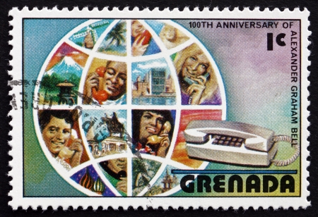 GRENADA - CIRCA 1976: a stamp printed in Grenada shows Globe and Telephone Users, Centenary of First Telephone Conversation by Alexander Graham Bell, circa 1976のeditorial素材