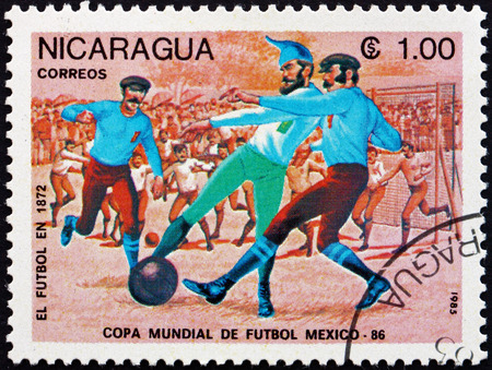 NICARAGUA - CIRCA 1985: a stamp printed in Nicaragua shows Evolution of Soccer, 1872, 1986 World Cup Soccer Championships, Mexico, circa 1985のeditorial素材