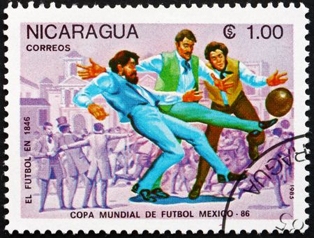 NICARAGUA - CIRCA 1985: a stamp printed in Nicaragua shows Evolution of Soccer, 1846, 1986 World Cup Soccer Championships, Mexico, circa 1985のeditorial素材