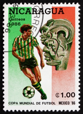 NICARAGUA - CIRCA 1986: a stamp printed in Nicaragua shows Soccer Player in Action and pre-Columbian Artifact, 1986 World Cup Soccer Championships, Mexico, circa 1986のeditorial素材