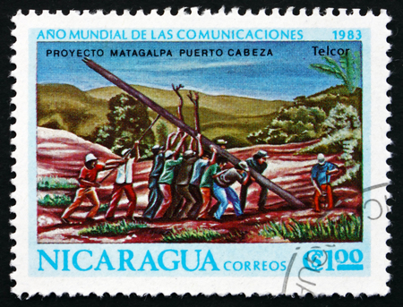 NICARAGUA - CIRCA 1983: a stamp printed in Nicaragua shows People at Work, World Communications Year, circa 1983のeditorial素材